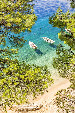 Two small boats anchored at Podrace Beach near Brela and Makarska, Croatia, Europe