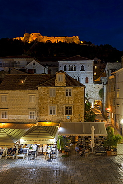 Elevated view over Svetog Stjepana square and the Spanish Fortress at night, Hvar, Croatia, Europe