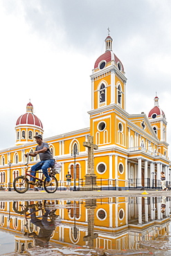 The Cathedral of Granada reflected in a puddle shortly after rainfall, Granada, Nicaragua, Central America