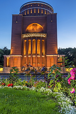 The illuminated Planetarium building in the Central Park at dusk, Hamburg, Germany, Europe