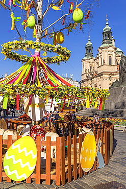 Easter Market at the old town market square with St. Nicholas Church in the background, Prague, Bohemia, Czech Republic, Europe