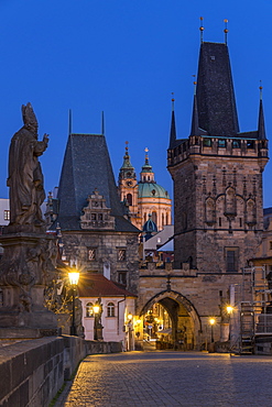 The Lesser Town Bridge Tower and St. Nicholas Church seen from Charles Bridge at dawn, UNESCO World Heritage Site, Prague, Bohemia, Czech Republic, Europe