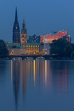 View from the Outer Alster Lake to the Elbphilharmonie, the town hall and St. Nikolai Memorial at dusk, Hamburg, Germany, Europe