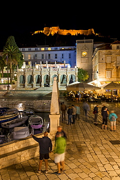 Night shot of the main square (Trg Svetog Stjepana) of Hvar Town with view to the Spanish Fortress in the background, Hvar, Croatia, Europe