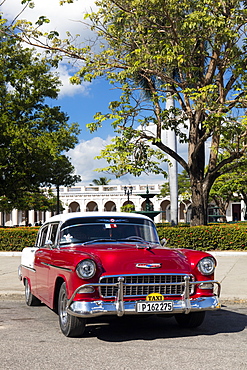 Red and white Chevrolet Bel Air parked by Plaza Jose Marti, Cienfuegos, UNESCO World Heritage Site, Cuba, West Indies, Caribbean, Central America