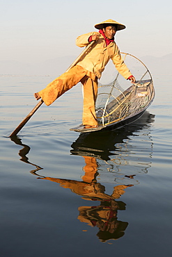 A fisherman rowing with one leg on Inle Lake, Shan State, Myanmar (Burma), Asia