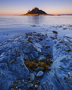 Sunrise with warm light making the granite walls golden at St. Michael's Mount in Marazion, Cornwall, England, United Kingdom, Europe