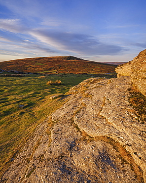 First sunlight on granite at the summit of Saddle Tor looking at Rippon Tor, Dartmoor National Park, Bovey Tracey, Devon, England, United Kingdom, Europe