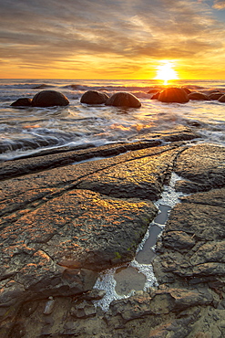 Spectacular sunrise at The Moeraki Boulders, Moeraki Beach, Otago, South Island, New Zealand, Pacific