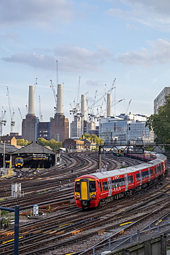 Gatwick Express passenger train travelling towards London Victoria station with Battersea Power Station under construction, London, England, United Kingdom, Europe