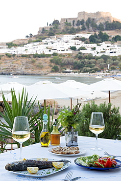 Fish and salad served at a Greek restaurant by the sea, Lindos, Rhodes, Dodecanese, Greek Islands, Greece, Europe