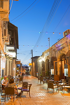 People eating at a restaurant outdoors at night in Latchi, Cyprus, Mediterranean, Europe