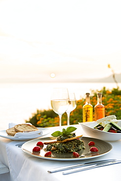 Food at a restaurant with a view over Pefkos Beach beach at sunset, Pefkos, Rhodes, Dodecanese, Greek Islands, Greece, Europe