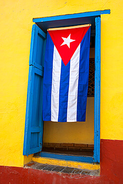 Cuban flag in doorway, Trinidad, Sancti Spiritus, Cuba, West Indies, Central America