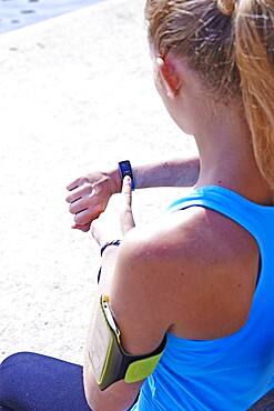 Woman checking her digital health tracker.