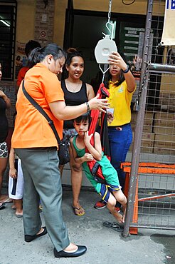 Weighing child.