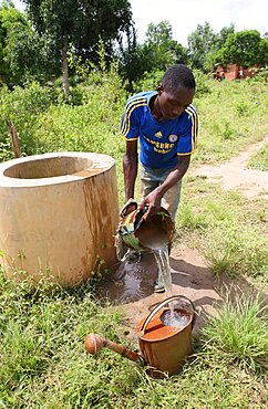 Man fetching water from well.