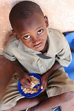 Child eating a meal in a primary school in Africa