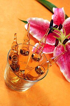 Still life with lilies and liquid in vials