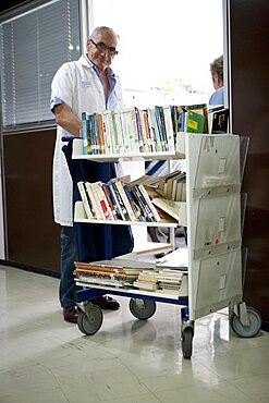 Volunteer Distributing Books In Hospital