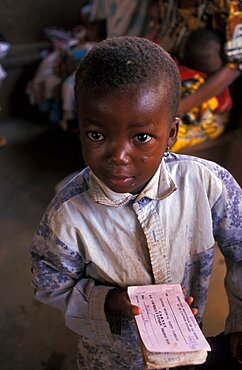 Burkina Faso, Little boy holding vaccination records