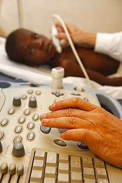 France, Paris, Young girl undergoing cardiological examination using modern equipment in charity clinic