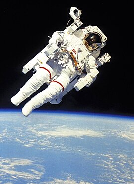 Astronaut in space suit floating in space