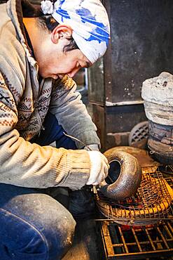 Takahiro Koizumi is putting the finishing touches at iron teapot or tetsubin, nanbu tekki, Workshop of Koizumi family,craftsmen since 1659, Morioka, Iwate Prefecture, Japan