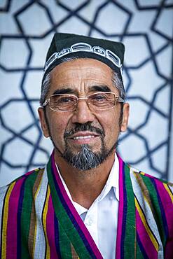 Poet, he sells his poems in the Courtyard of Ulugbek Medressa, Registan, Samarkand, Uzbekistan