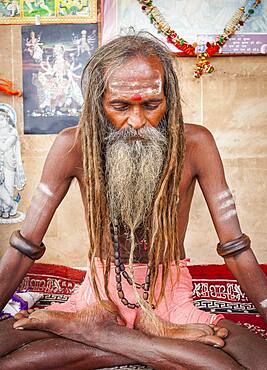 Sadhu meditating, in the ghats of Ganges river, Varanasi, Uttar Pradesh, India.