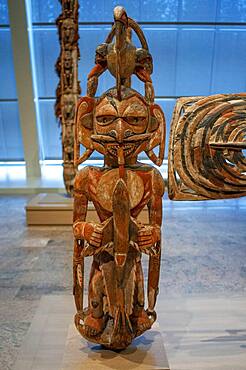 New Ireland Malagan funerary statue in at the Metropolitan Museum of Art museum, New York, USA.  New Ireland is part of the Bismarck Archipelago, situated north of New Guinea, and has an estimated population of 100,000. The Dutch first encountered the island in 1616, and today New Ireland is a province of Papua New Guinea. Nineteen different languages are spoken on the island, and it is divided by a chain of mountains into three distinct regions: northern, central, and southeastern. The art of New Ireland traditionally centered on mortuary ceremonies and feasts to honor the dead. In northern New Ireland, the name given to these elaborate ceremonies is malagan, which is also the term used for the carved and painted sculptures associated with the ceremonies.