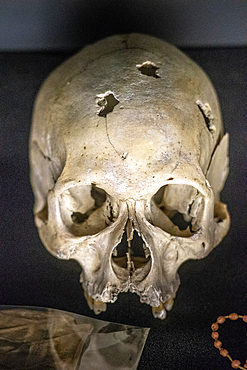 Damaged skulls of known victims of the 1994 Rwandan Genocide remain interred inside of of the Kigali Genocide Memorial as a testament to those lost in the brutality, Kigali, Rwanda.