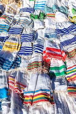 Scarves and textiles layered on top of one another for sale, Debre Berhan, Ethiopia