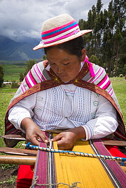 Quechua woman weaving cloth in village of Misminay, Sacred Valley, Peru.