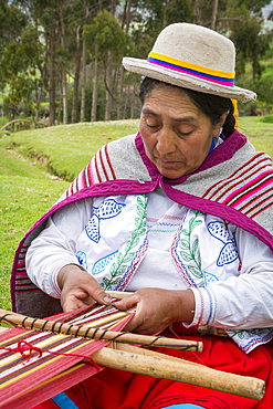 Quechua woman weaving cloth in Misminay Village, Sacred Valley, Peru.