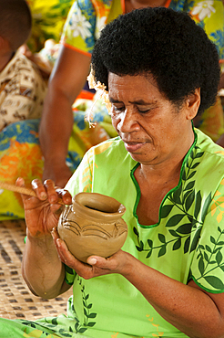 Woman making traditional pottery in Lawai village, Viti Levu Island, Fiji.