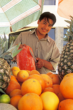 Street vendor with fruit cart in downtown Cabo San Lucas, Baja California Sur, Mexico.