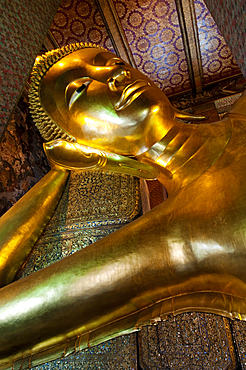 The Reclining Buddha at Wat Pho, the largest Buddhist temple in Bangkok, Thailand, and birthplace of Thai massage.