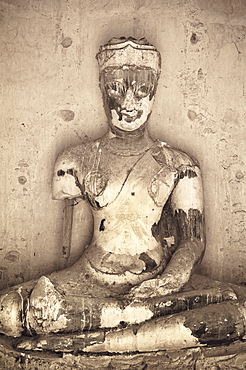 Ancient Buddha statue at Wat Chaiwatthanaram Buddhist temple ruins in Ayutthaya, Thailand.