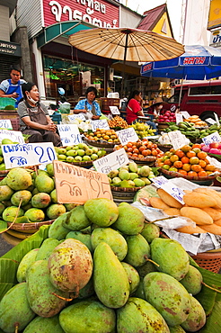 Fruit vendors at Pratu Chiang Mai morning market in Chiang Mai, Thailand.