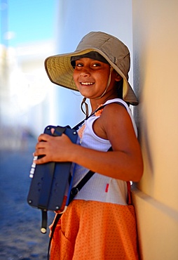 Girl playing the accordion in the streets of Santorini, Greek Islands, Greece