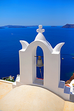 Church bell and hillside buildings in Oia, Santorini, Greek Islands, Greece