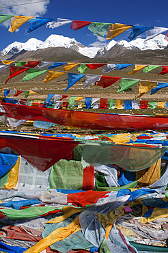 La Ken La pass or Laken pass at 5190 metres on the road to remote Nam Tso Lake Tibet. Namtso Lake Tibet China. Prayer flags next to the base of Mount Nyenchen Tanglha 7111 meters high, Tibet China. One of the holy mountains for Tibetans. The Nyenchen Tanglha is the highest peak of the Nyainqentanglha mountain. It is located near Lhasa, on the Qinghai-Tibet paved road. It is surrounded by grassy plains from Damshung to the south and to the picturesque sacred Nam Tso Lake (4,700 m, one of the largest lakes in the world) in the north.