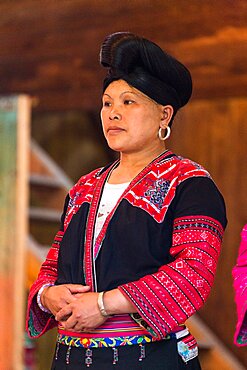 Portrait of a Red Yao ethnic minority woman showing her characteristic traditional attire, Huangluo, China.