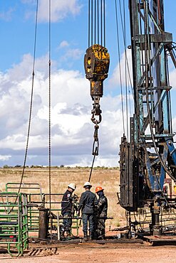 The well service crew on a workover rig works on an oil well to try to bring it back into service.