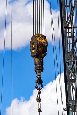 The traveling block on a portable truck-mounted oil well service workover rig in Utah.