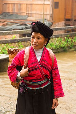 A woman of the Red Yao ethnic minority in traditional attire at the Jinkeng rice terraces, Longshen, China.