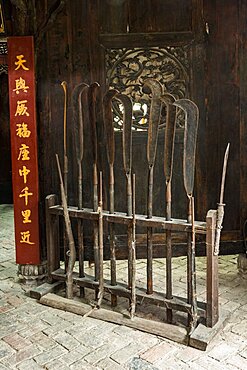 Vintage firearms and halberds on display in a museum about banditry in Furong, China.