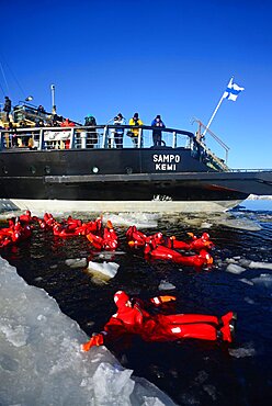 Swimming in the frozen sea during Sampo Icebreaker cruise, an authentic Finnish icebreaker turned into touristic attraction in Kemi, Lapland