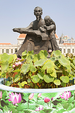 Statue of Ho Chi Minh holding a child, outside People's Committee Building, Ho Chi Minh City, (Saigon), Vietnam